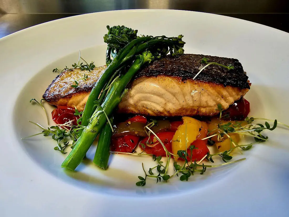 Skin on pan seared salmon with vegetables